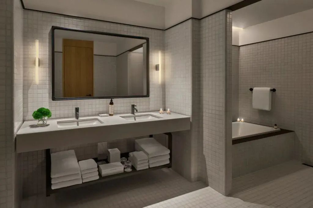 Luxuriöses Badezimmer mit Doppelwaschbecken, großem Spiegel und separater Badewanne.
