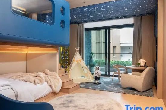 Kinderzimmer der Familie Suite mit blauem Etagenbett, Spielzelt und Sternenhimmel an der Decke.
