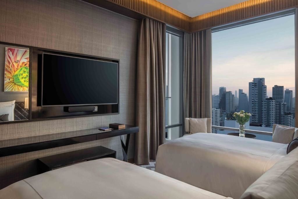 Modernes Zweibettzimmer in der Rattanakosin Suite mit Panoramablick auf die Stadt.