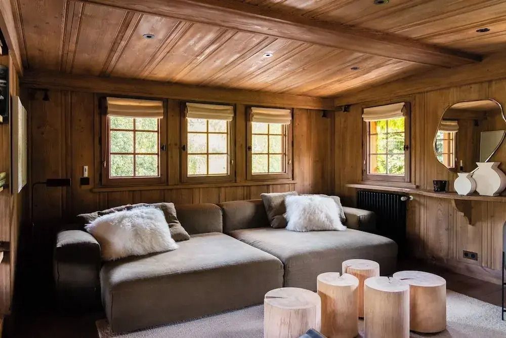 Einladendes Wohnzimmer mit bequemen Sofas und Holzakzenten im Chalet.