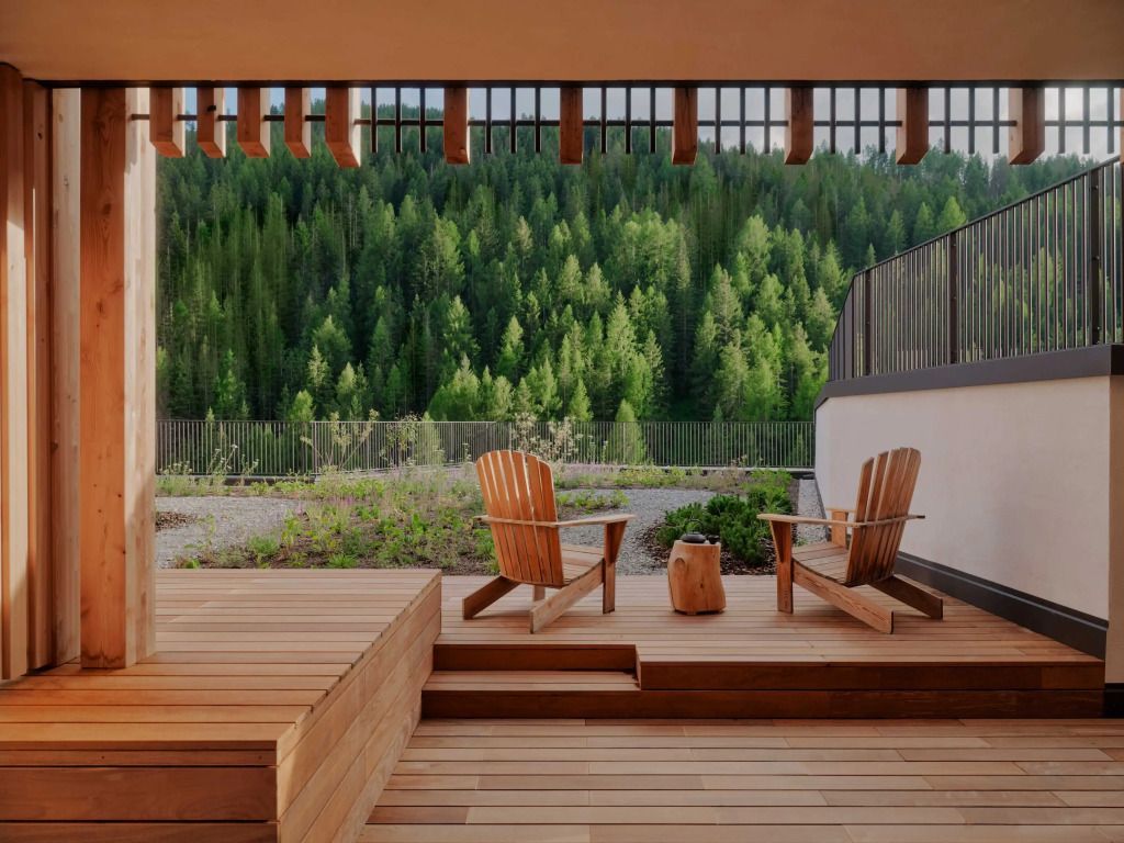 Terrasse mit Holzstühlen und Blick auf den Wald im Aman Rosa Alpina