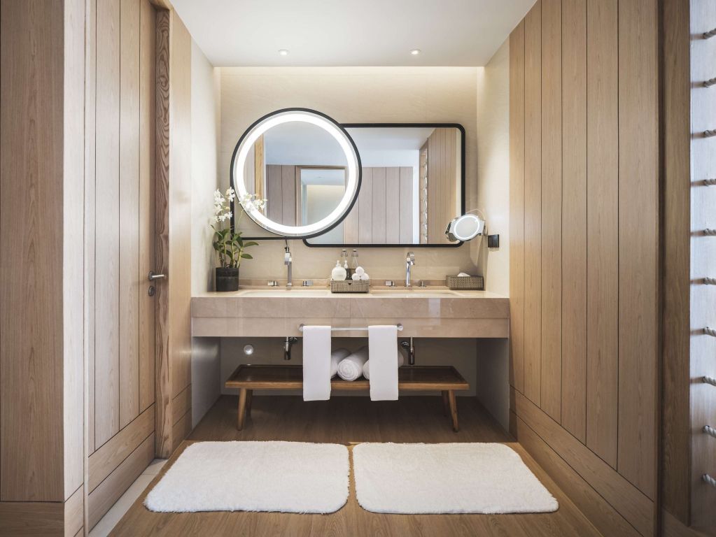 Modernes Badezimmer mit stilvoller Beleuchtung und großem Spiegel