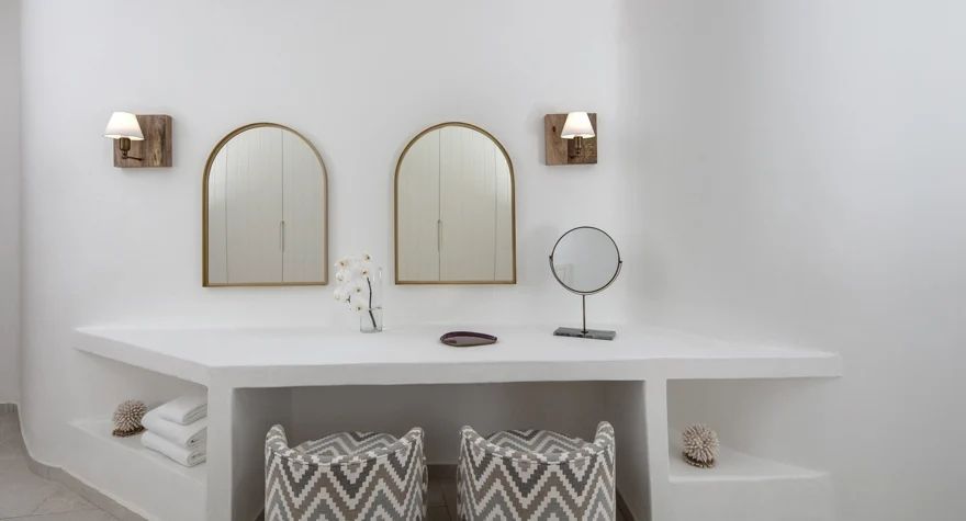 Schminktisch mit Spiegeln und stilvoller Dekoration im Zimmer.