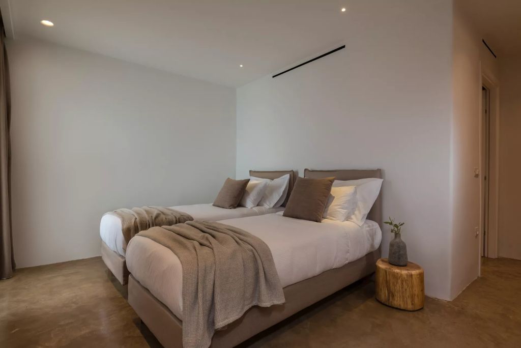 Modernes Schlafzimmer mit zwei Einzelbetten und eleganten Textilien