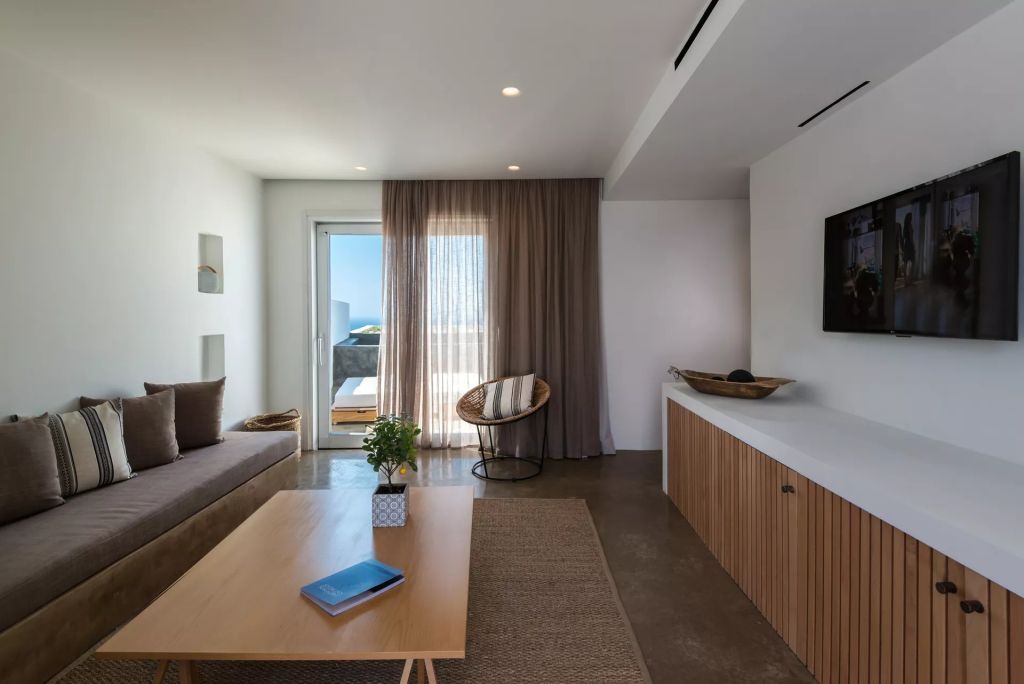 Heller Wohnbereich mit Sofa, Tisch und Zugang zur Terrasse