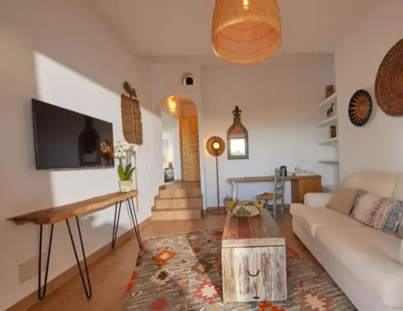 Einladender Wohnbereich mit Teppich, Sofa und Wandkunst