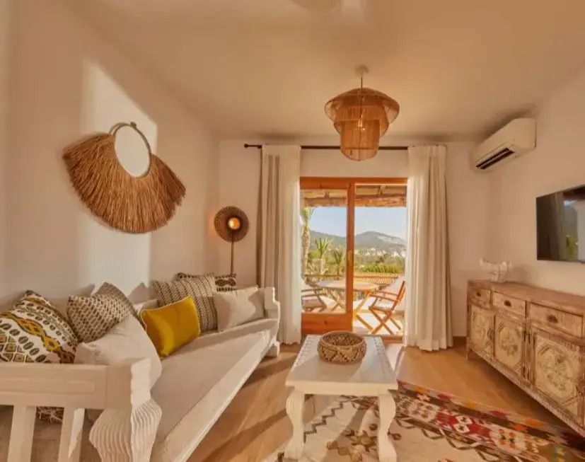 Gemütlicher Wohnraum mit traditionellem Dekor und Zugang zur Terrasse.
