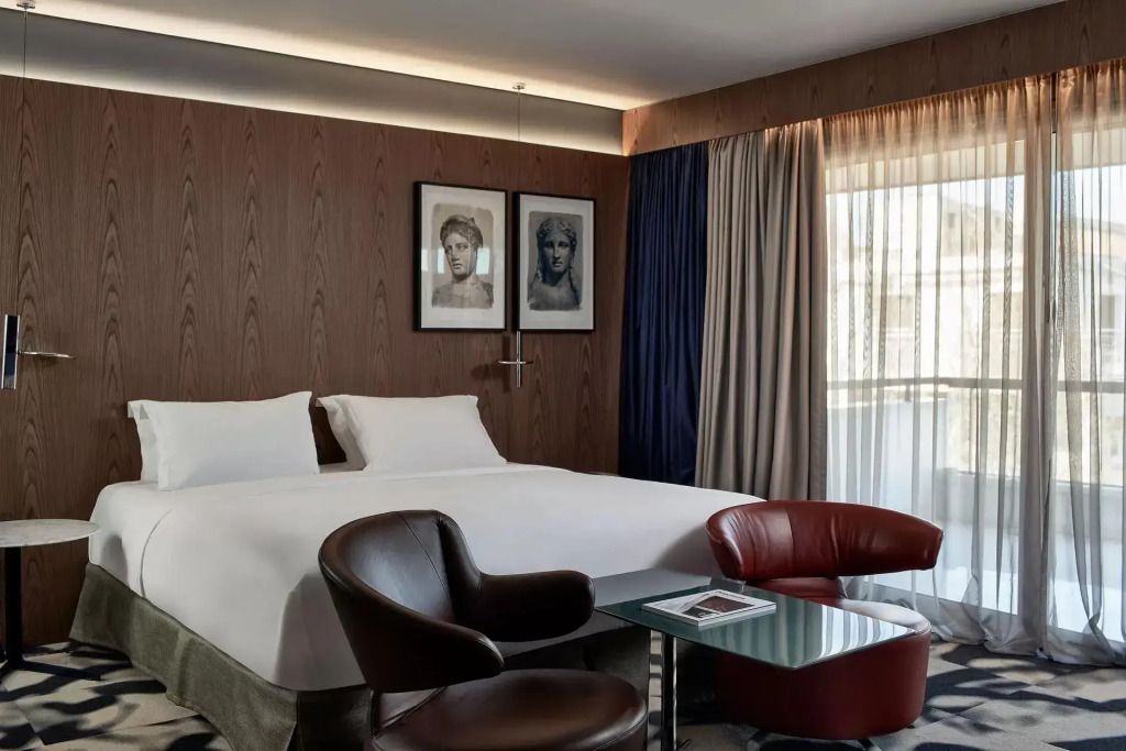 Moderne Suite mit Doppelbett und stilvollen Sesseln