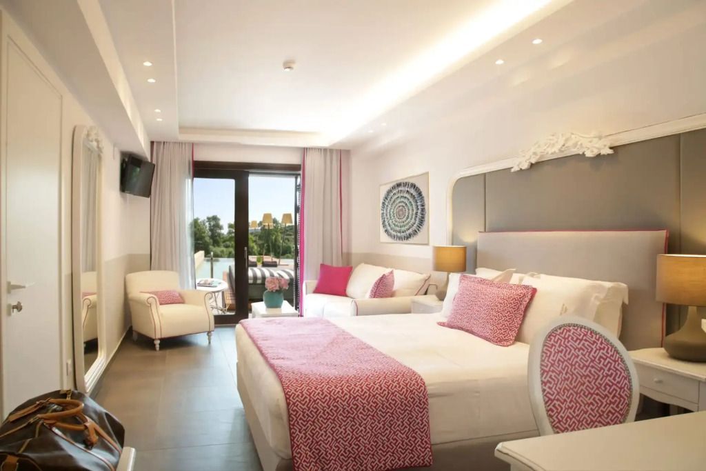 Helle Junior-Suite mit Doppelbett, gemütlicher Sitzecke und Balkonzugang