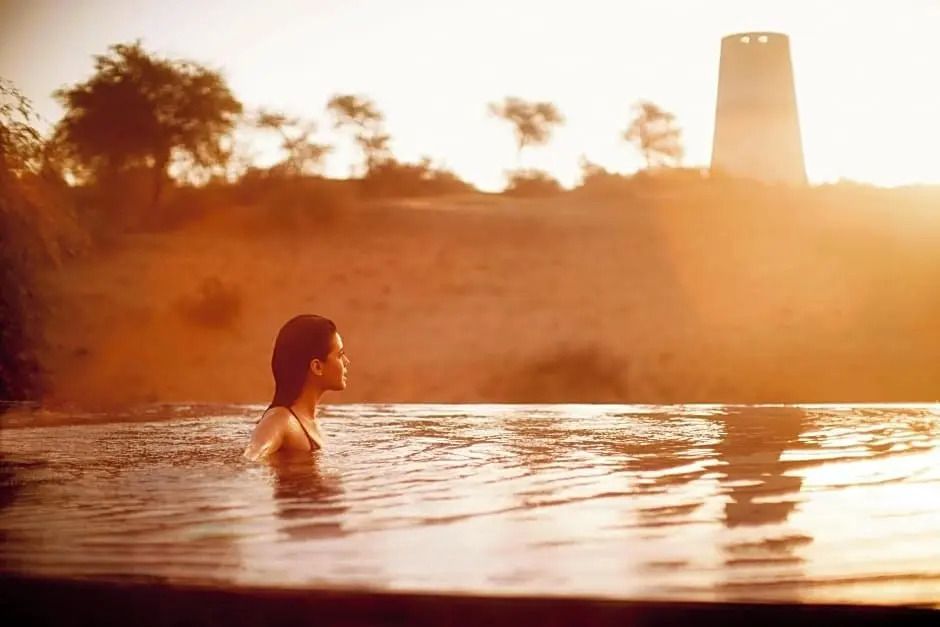 Erfrischende Infinity-Pool-Erfahrung mit Blick auf die Wüste bei Sonnenuntergang
