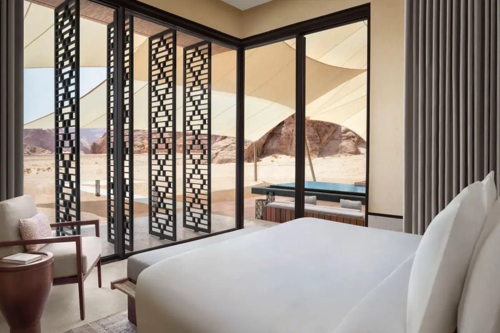 Schlafzimmer mit Panoramafenster und Blick auf die Wüste im Banyan Tree AlUla