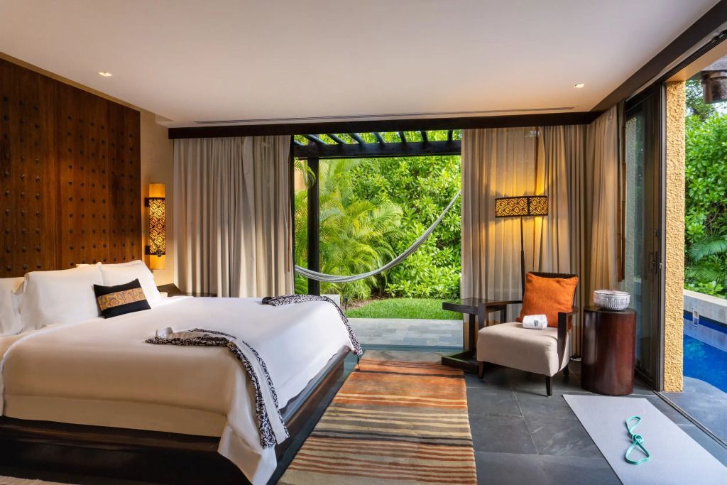 Elegante Villa mit großzügigem Doppelbett und Blick auf den üppigen Garten