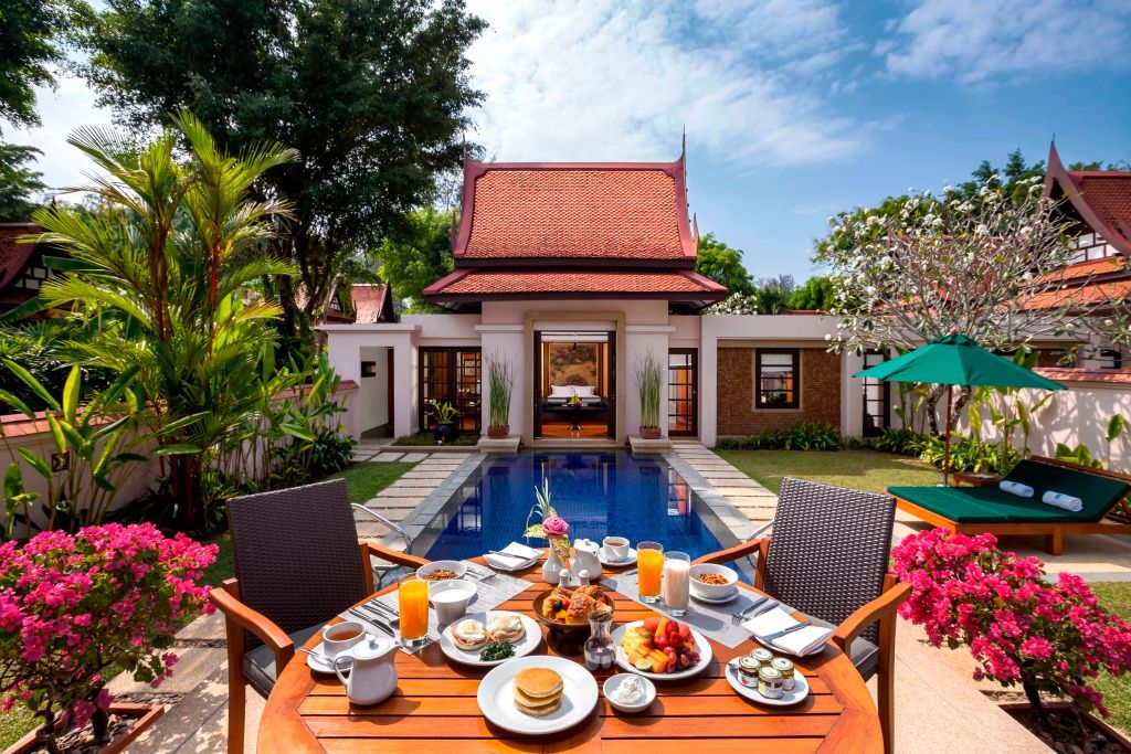 Terrasse mit Frühstückstisch und Blick auf privaten Pool und traditionelle Villa