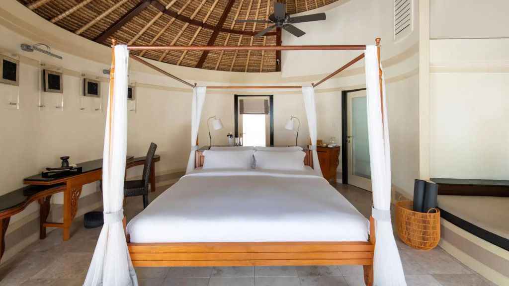 Helles Schlafzimmer mit Himmelbett und rundem Strohdach