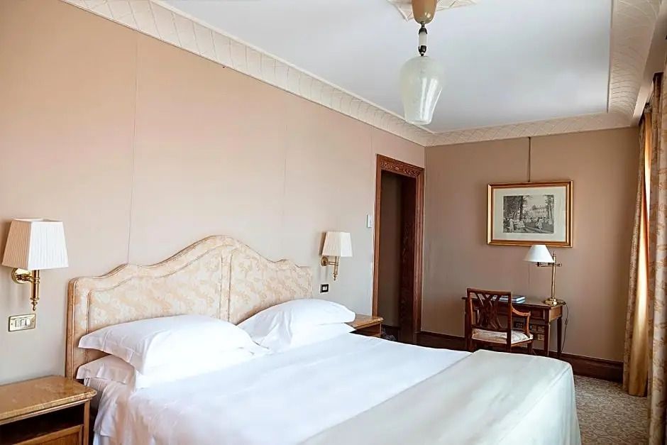 Helles Zimmer mit Doppelbett und klassischem Dekor
