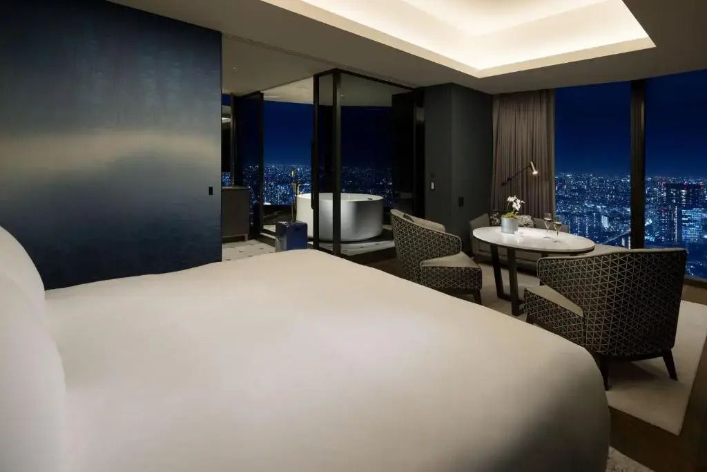 Moderne Suite mit großem Bett, Sitzbereich und Panoramafenster mit atemberaubender Aussicht