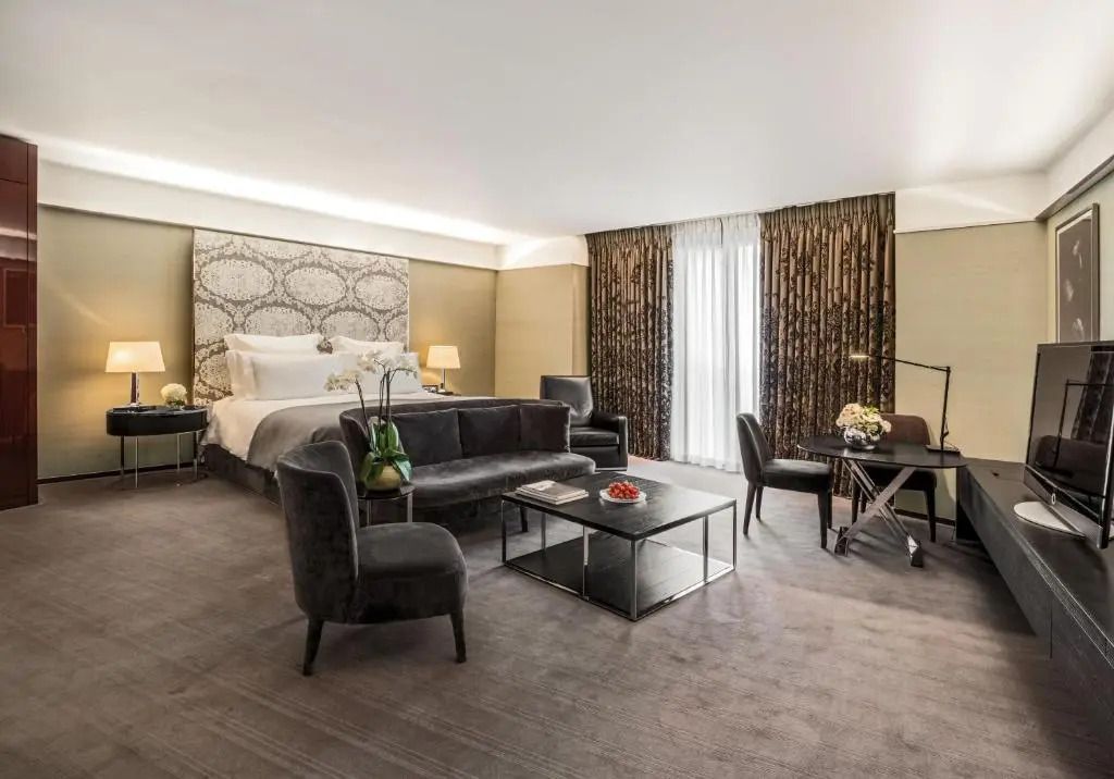 Großzügige Junior-Suite mit Doppelbett und eleganten Vorhängen im Bvlgari Hotel London