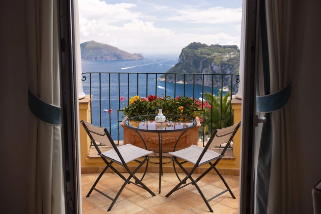 Balkon mit Tisch und Stühlen sowie spektakulärem Meerblick