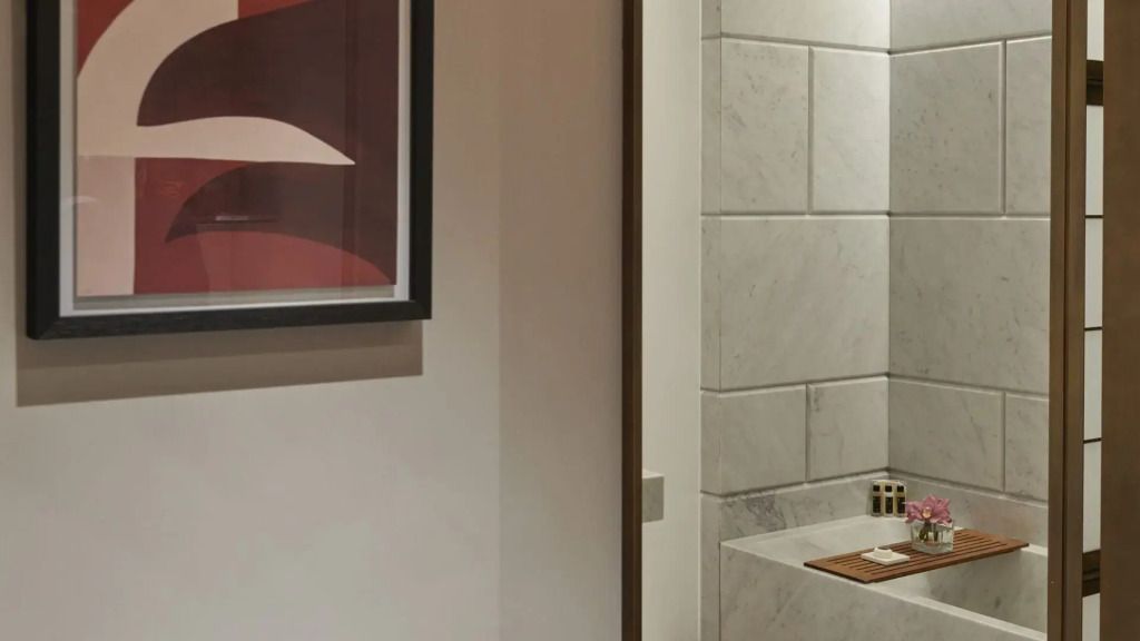 Modernes Badezimmer mit Kunst an der Wand und weißen Fliesen