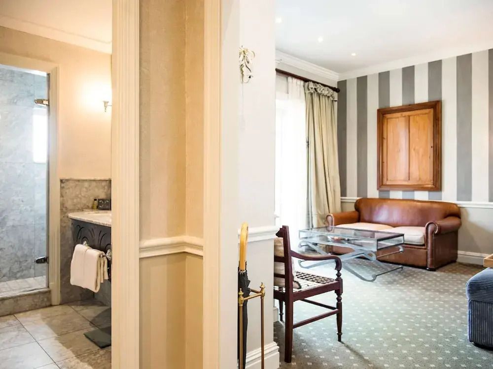 Geräumiges Schlafzimmer mit Sitzecke und eleganten Beige- und Brauntönen