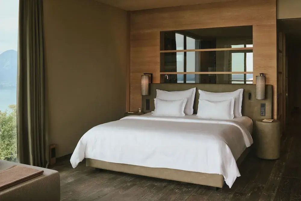 Gemütliches Doppelbett in der Deluxe Suite mit eleganter Holzakzentwand