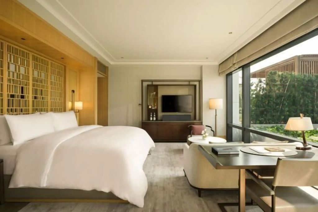 Helles Hotelzimmer mit Doppelbett und moderner Einrichtung
