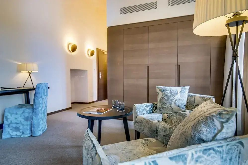 Sitzecke mit stilvollen Sesseln und Holzmöbeln im Deluxe Zimmer