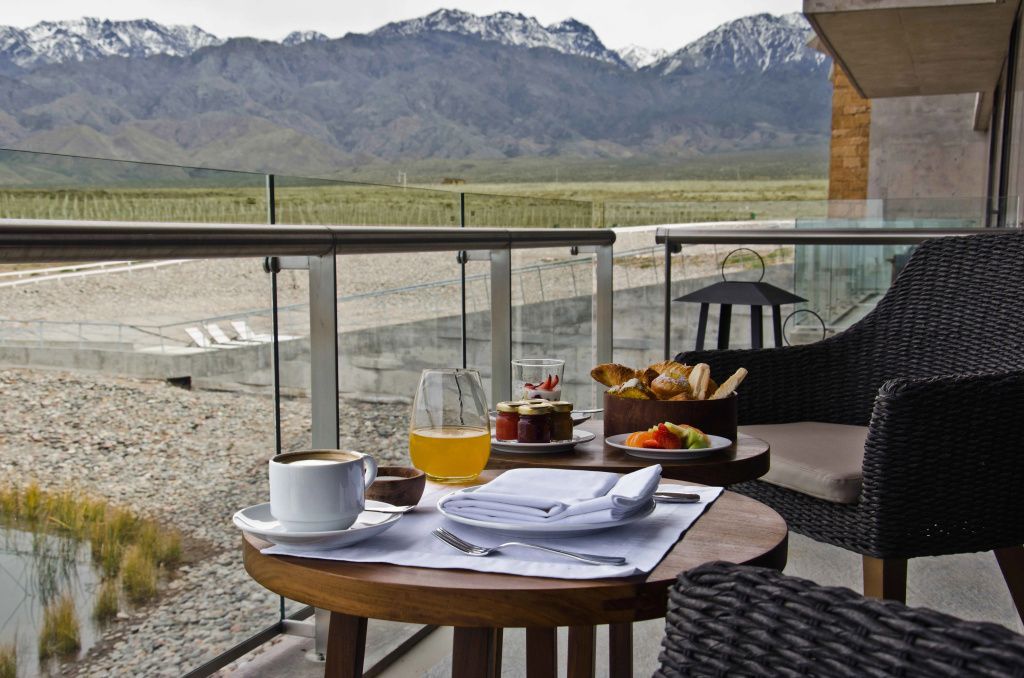 Frühstück auf einem Balkon mit Blick auf die Anden und Weinberge.