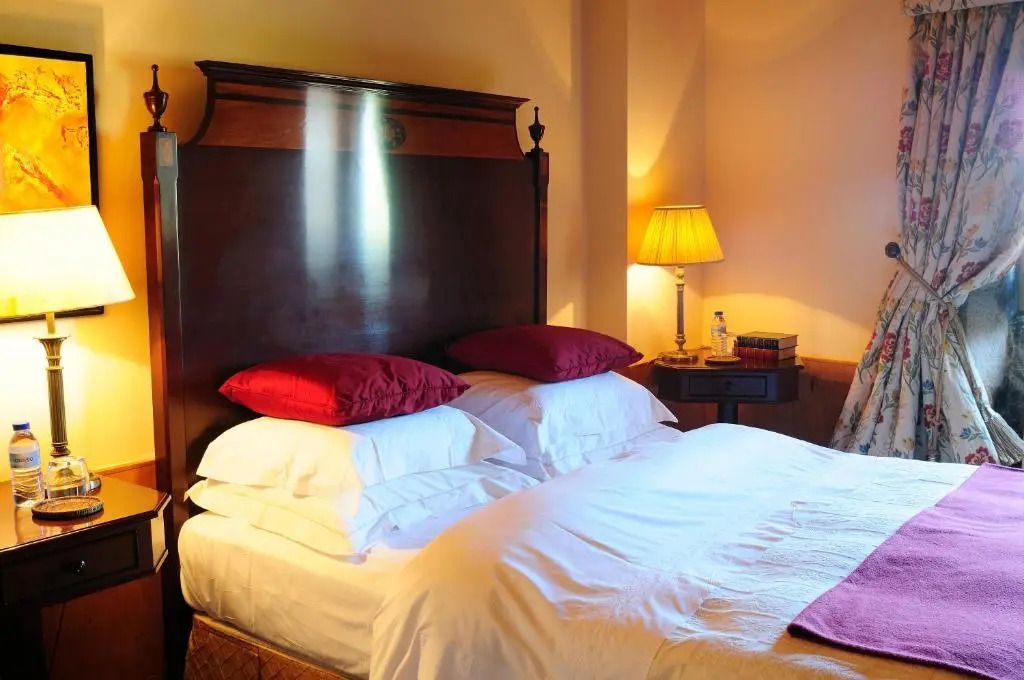 Komfortables Doppelbett mit raffinierter Beleuchtung und klassischem Nachttisch