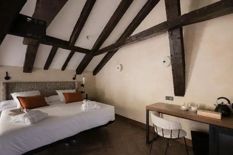 Elegantes Zimmer mit Doppelbett und Schreibtisch im Castilla Termal Brihuega