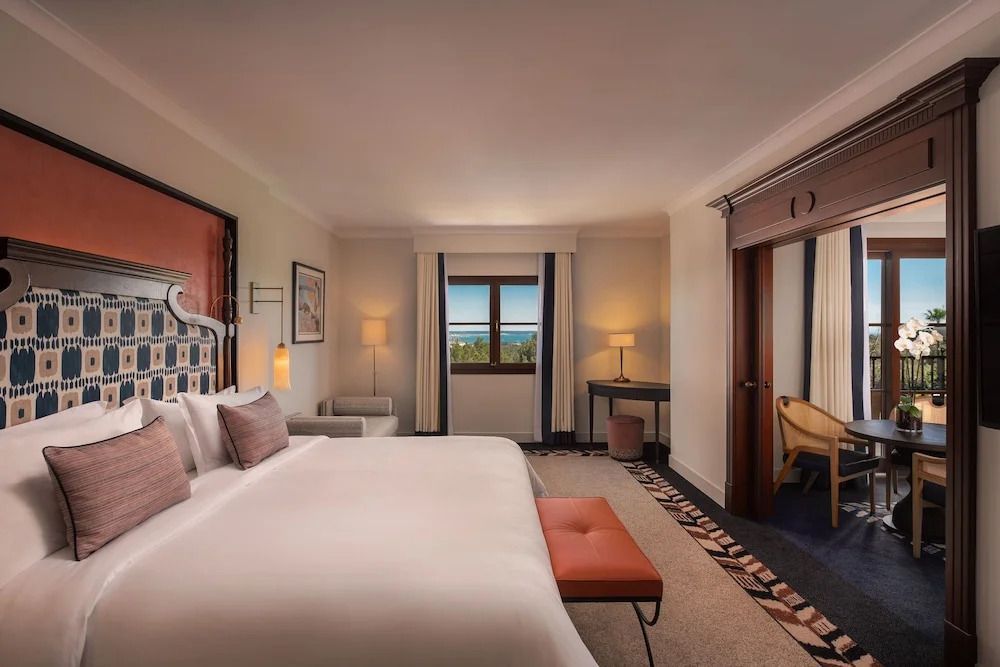 Elegantes Schlafzimmer in der Deluxe Suite mit Meerblick und luxuriösem Interieur.