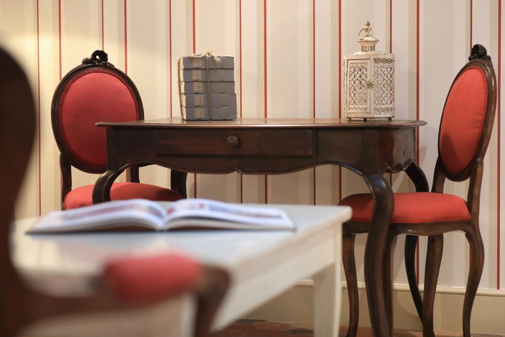Eleganter Schreibtisch mit roten Stühlen und Dekoration