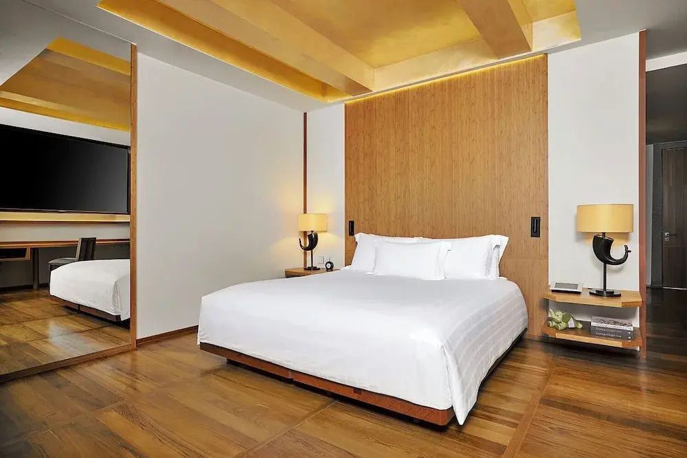 Deluxe-Zimmer mit modernem Design, Holzakzenten und komfortablem Bett.