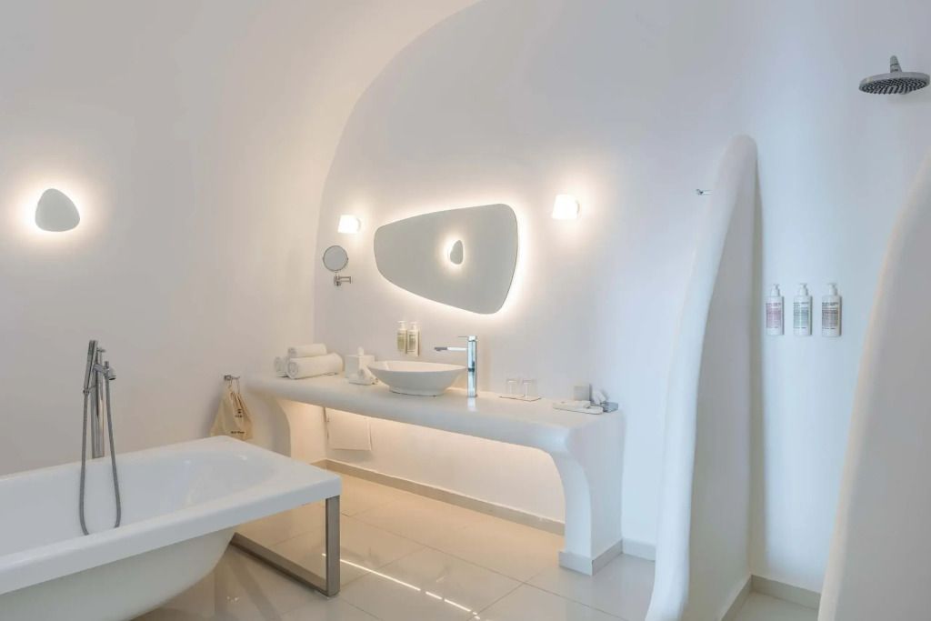 Modernes Badezimmer in der Honeymoon Suite mit eleganter Beleuchtung und stilvollem Waschbecken.