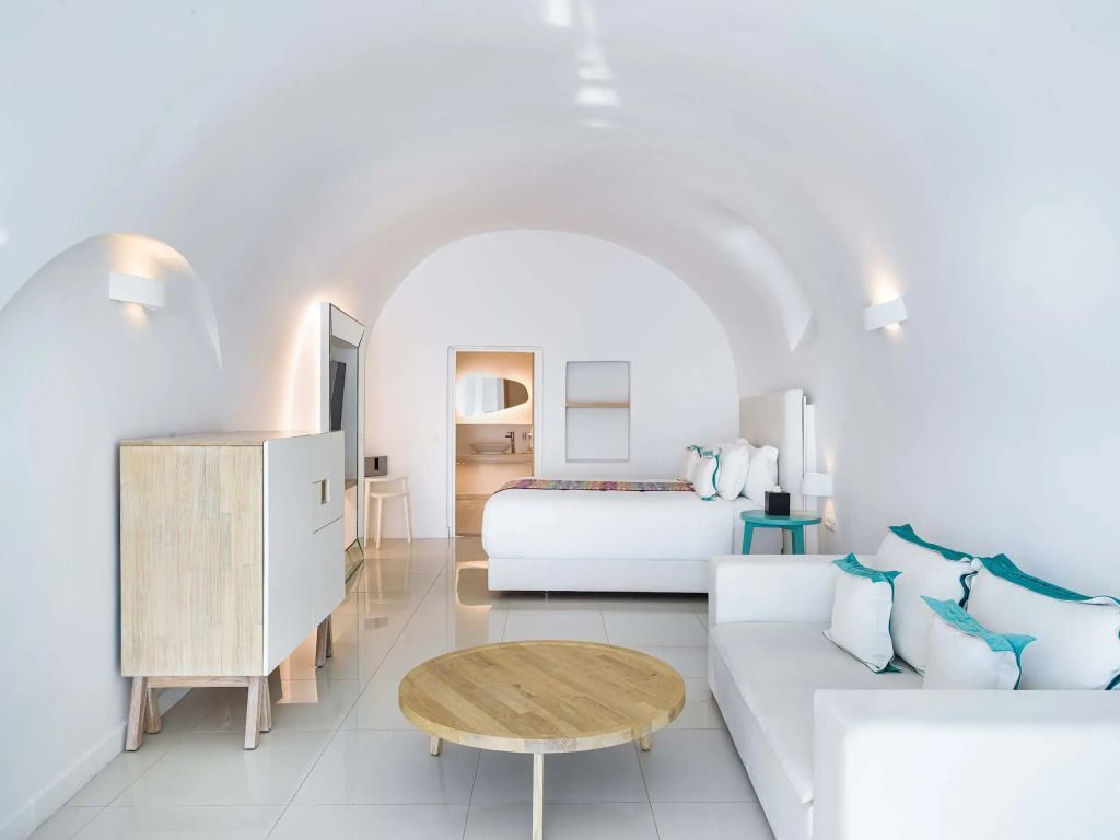 Geräumiges Zimmer mit Sitzbereich und Doppelbett in moderner, heller Ausstattung