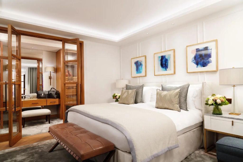 Elegantes Doppelzimmer mit moderner Kunst an den Wänden und luxuriösem Bett.