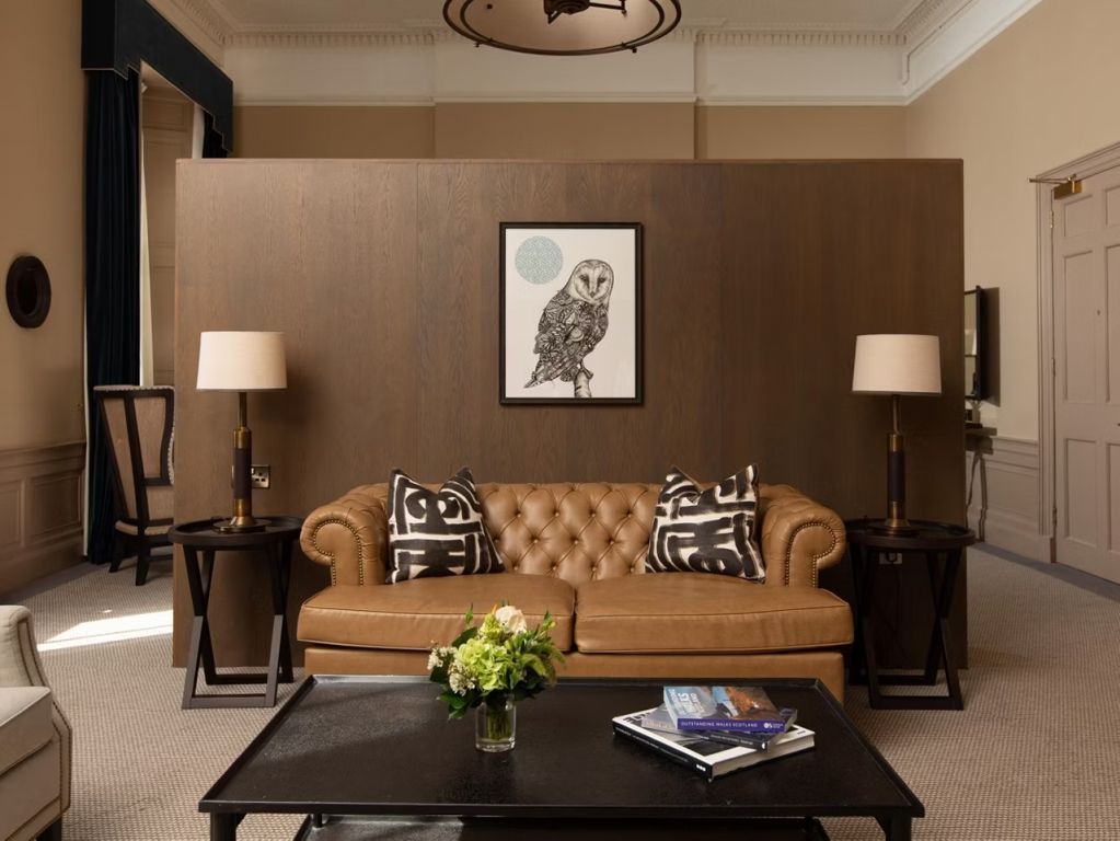 Einladende Lounge mit stilvollem Ledersofa und durchdachter Dekoration.