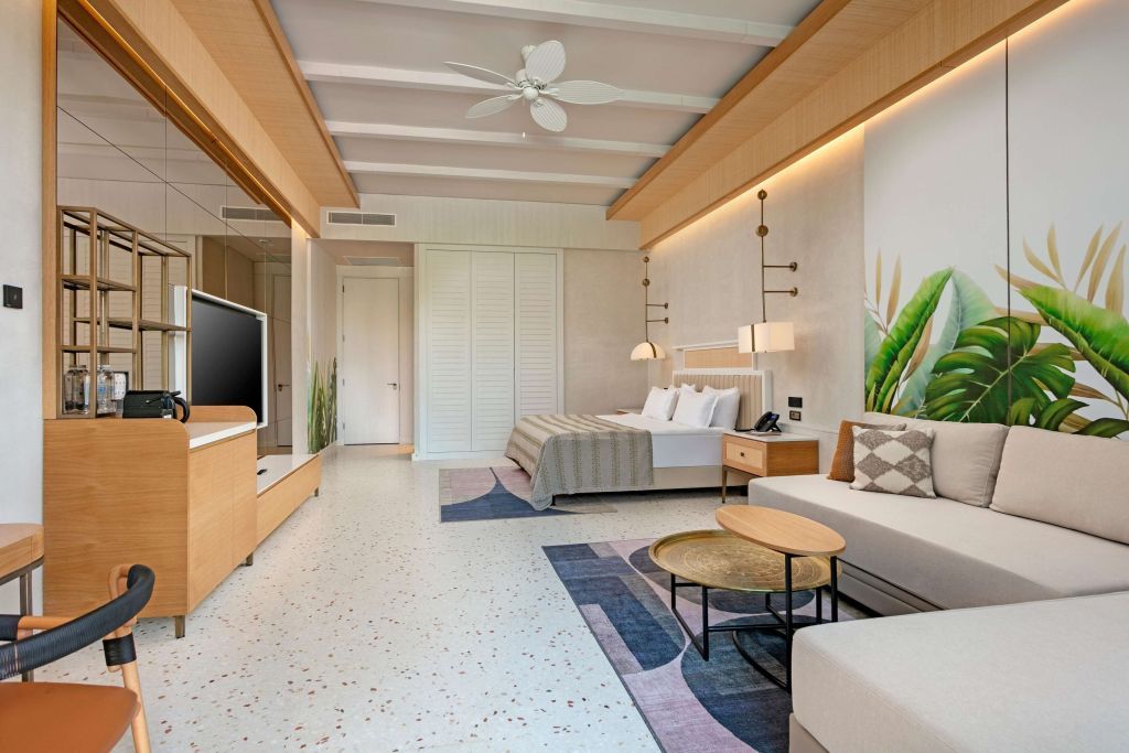 Modernes Doppelzimmer mit gemütlichem Sitzbereich und stilvollem Dekor.