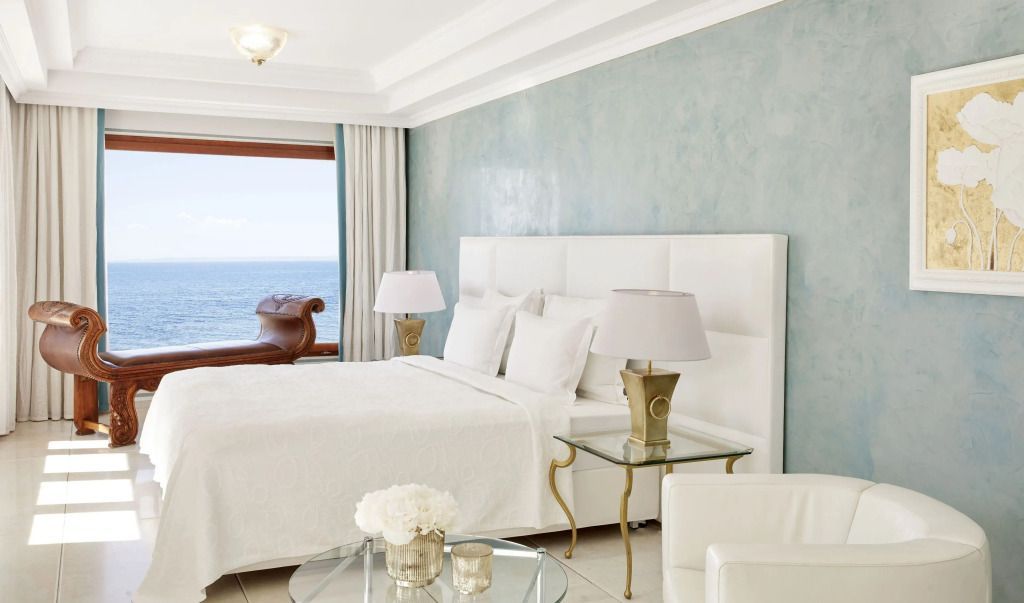 Elegantes Schlafzimmer mit Meerblick und luxuriöser weißer Einrichtung