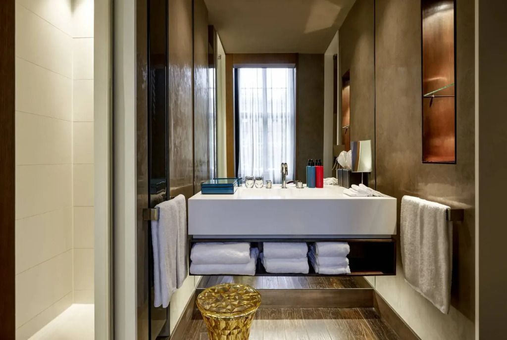 Modernes Badezimmer mit Spiegel, Waschbecken und Handtüchern