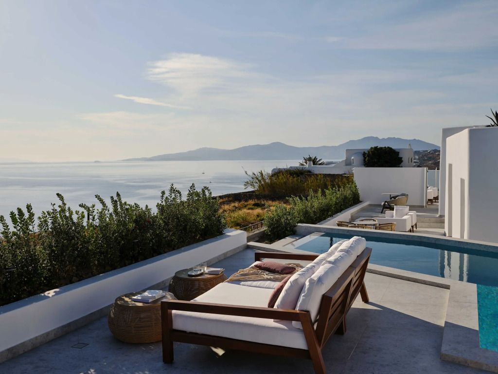 Zwei Liegestühle auf Terrasse mit Pool und Panoramablick