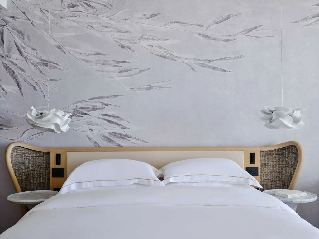 Helles Schlafzimmer mit stilvollem Kopfteil und dezenter Wanddekoration