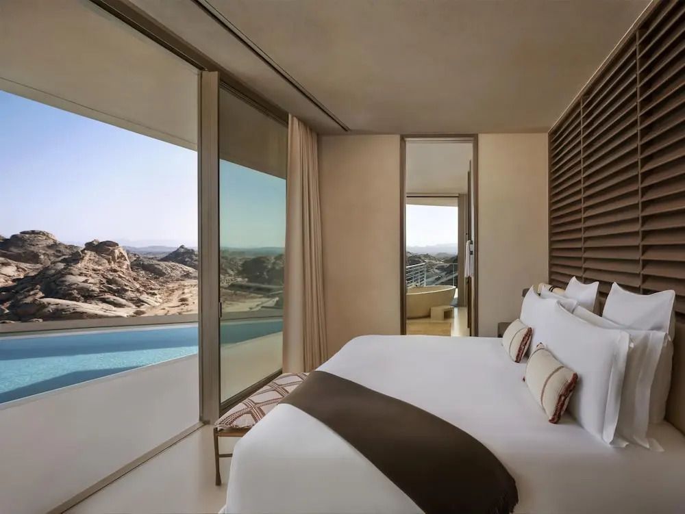 Luxuriöses Schlafzimmer mit Blick auf die Wüste und einen privaten Pool.