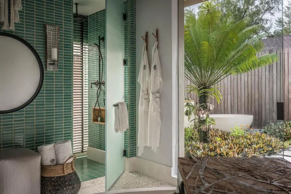Exquisites Badezimmerdetail mit grünen Fliesen und direktem Zugang zum Garten