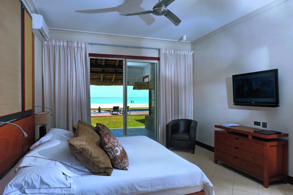 Helles Schlafzimmer mit Terrasse und Meerblick im Dinarobin Villa