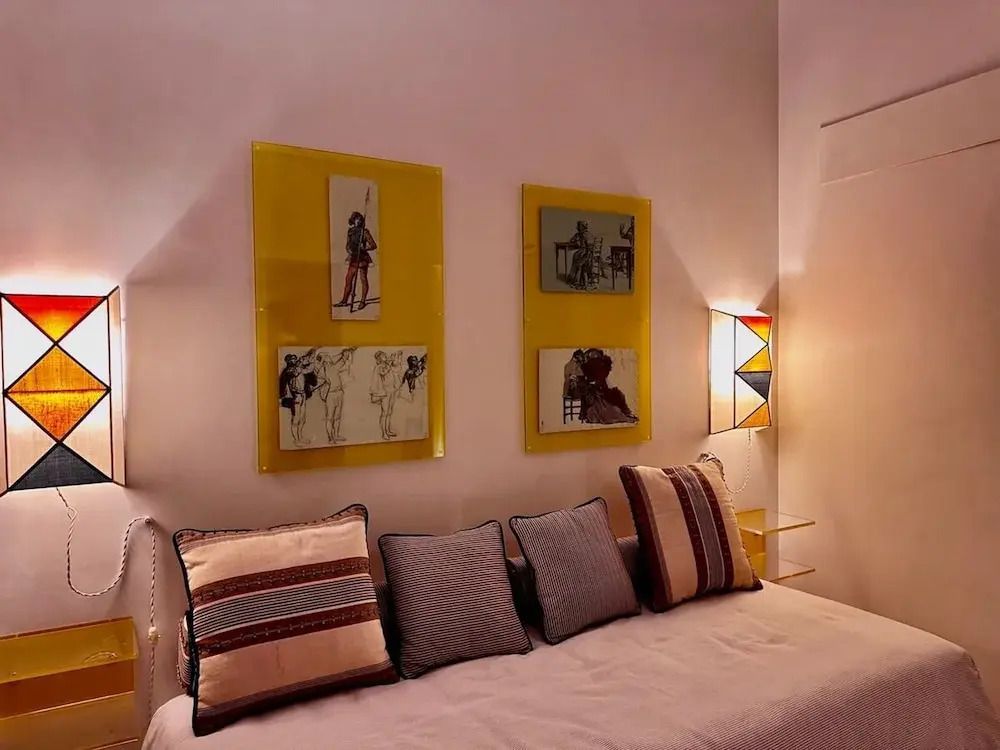 Stilvoll dekoriertes Wohnzimmer mit Sofakissen und moderner Kunst an der Wand