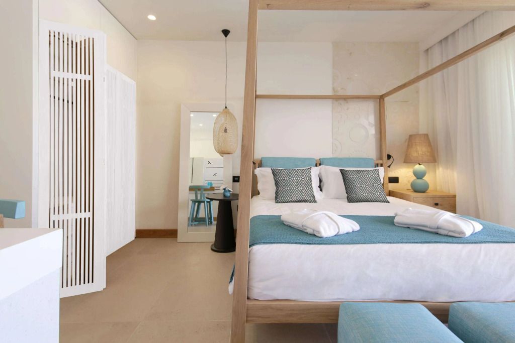 Modern eingerichtetes Schlafzimmer mit Himmelbett und Poolblick.