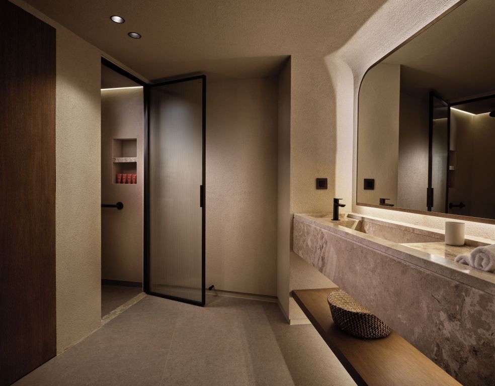 Modernes Badezimmer mit geräumigem Waschbecken und großer Spiegelwand
