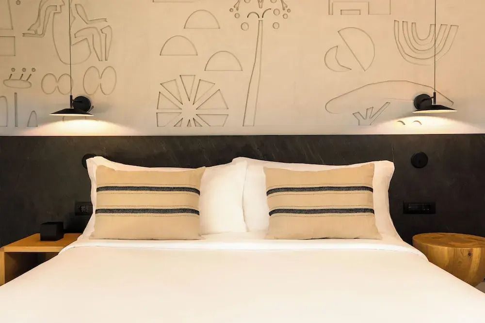 Elegantes Doppelbett mit stilvollen Kissen im Bungalow.