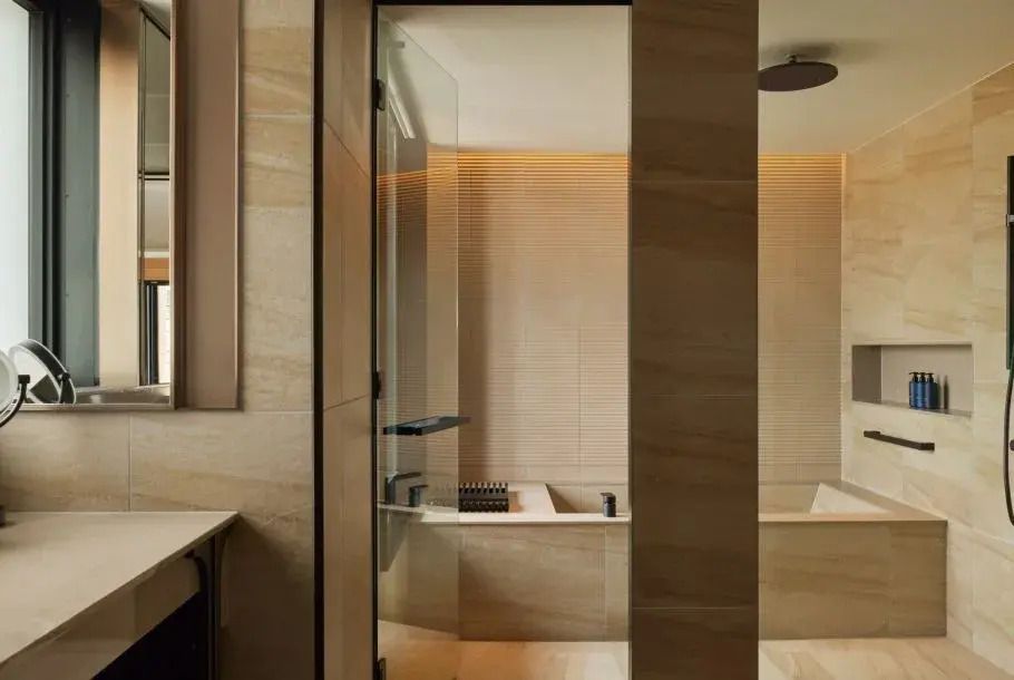 Modernes Badezimmer mit Glasdusche und stilvollen beigen Fliesen